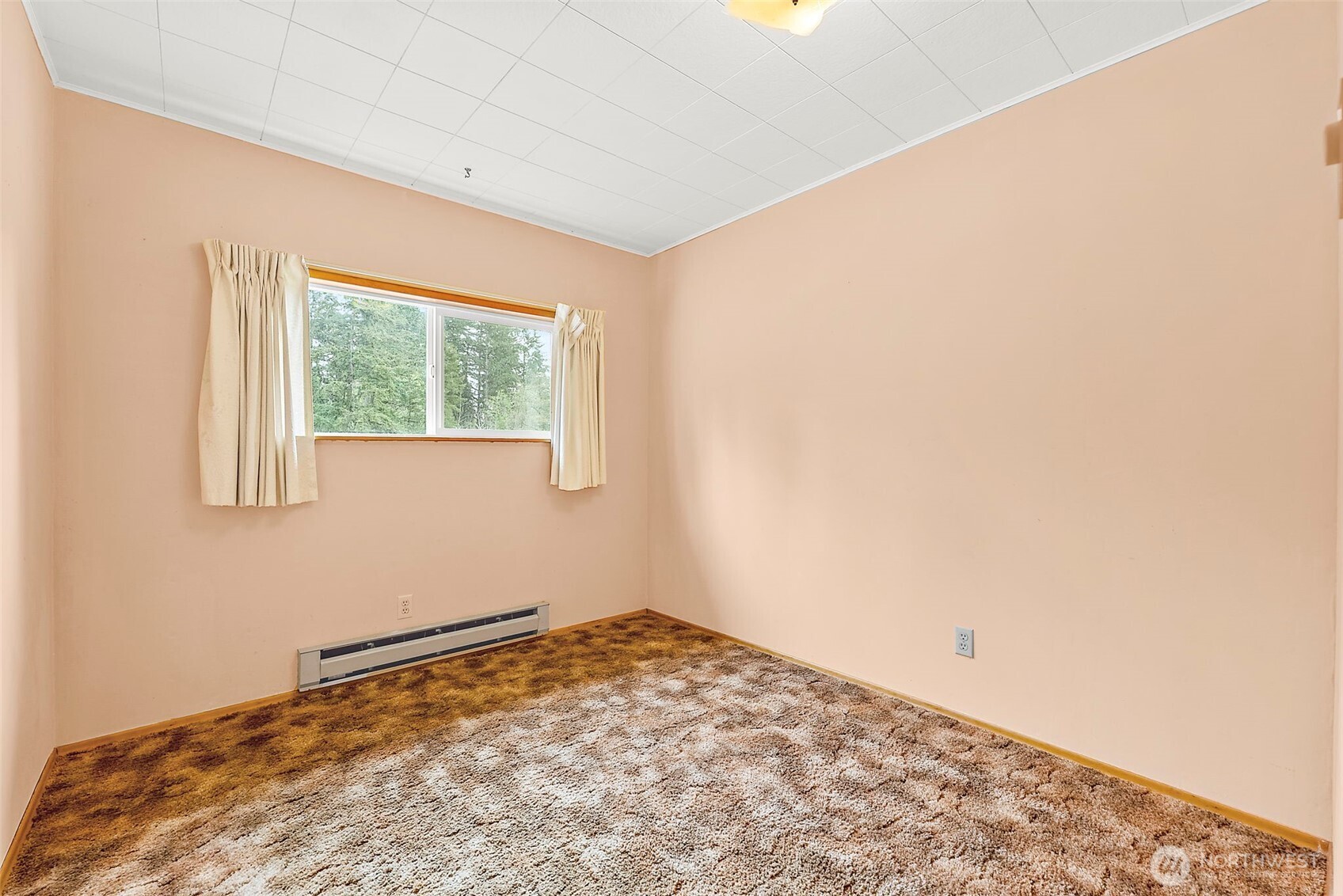 12106 County Line Road East Edgewood, WA 98372 - Photo 15 of 31 a view of a room with a wooden floor and a window