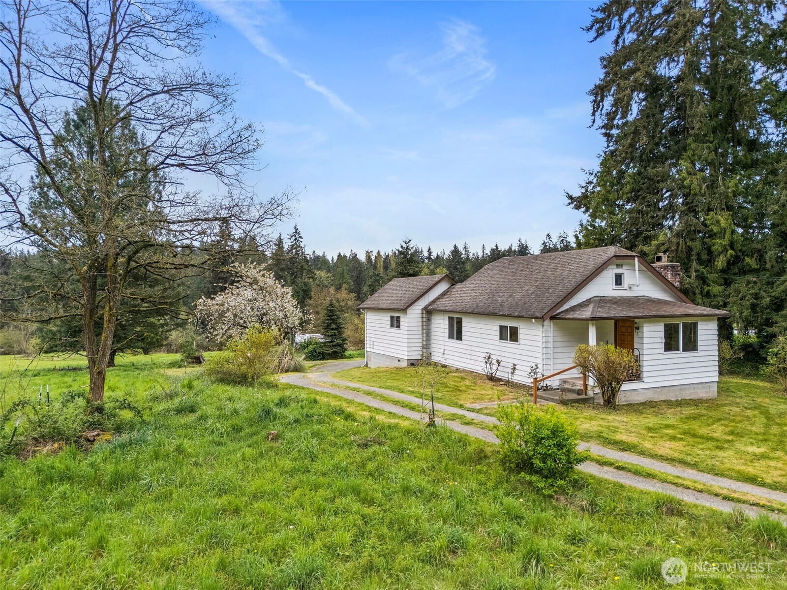 12106 County Line Road East Edgewood, WA 98372 - Photo 25 of 31 a view of a house with a big yard and large trees