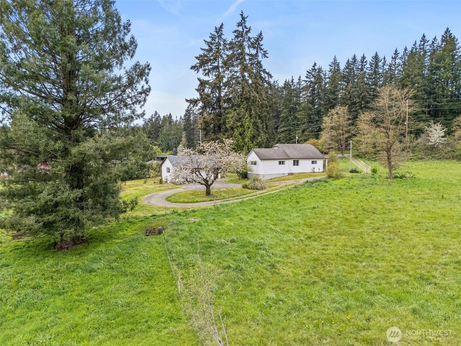 12106 County Line Road East Edgewood, WA 98372 - Photo 28 of 31 a view of a house with backyard sitting area and garden