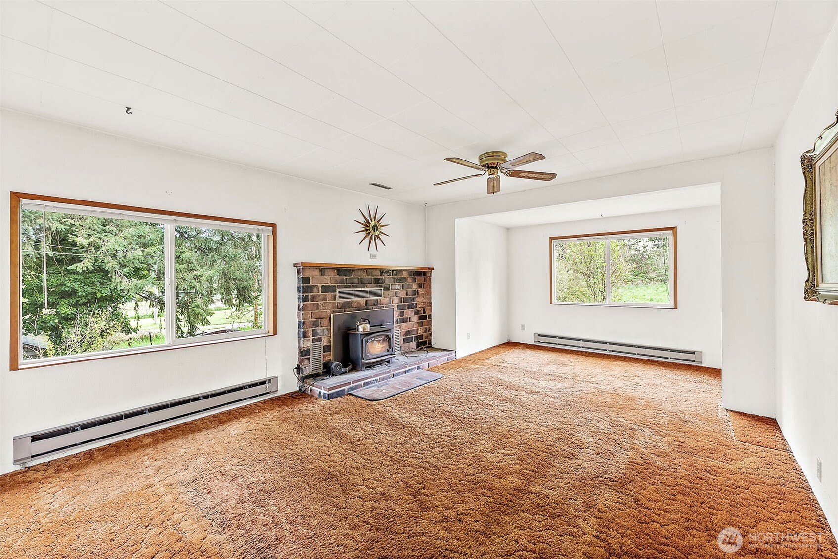 12106 County Line Road East Edgewood, WA 98372 - Photo 5 of 31 a view of an empty room with a window and a fireplace