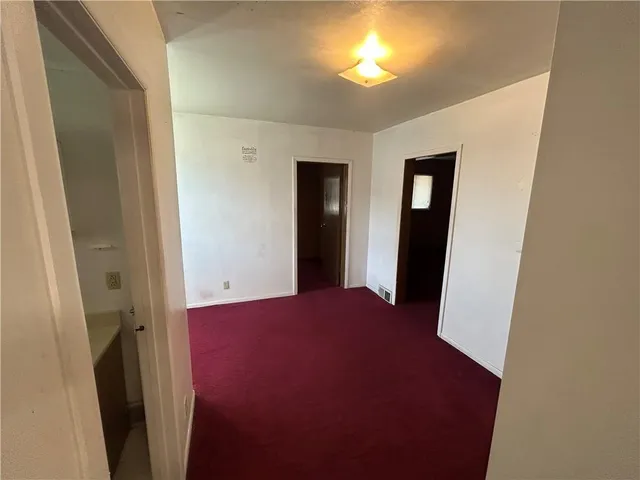 a view of hallway with window and stairs
