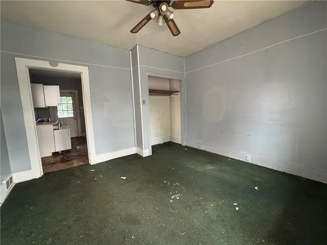 a view of a room with wooden floor and windows