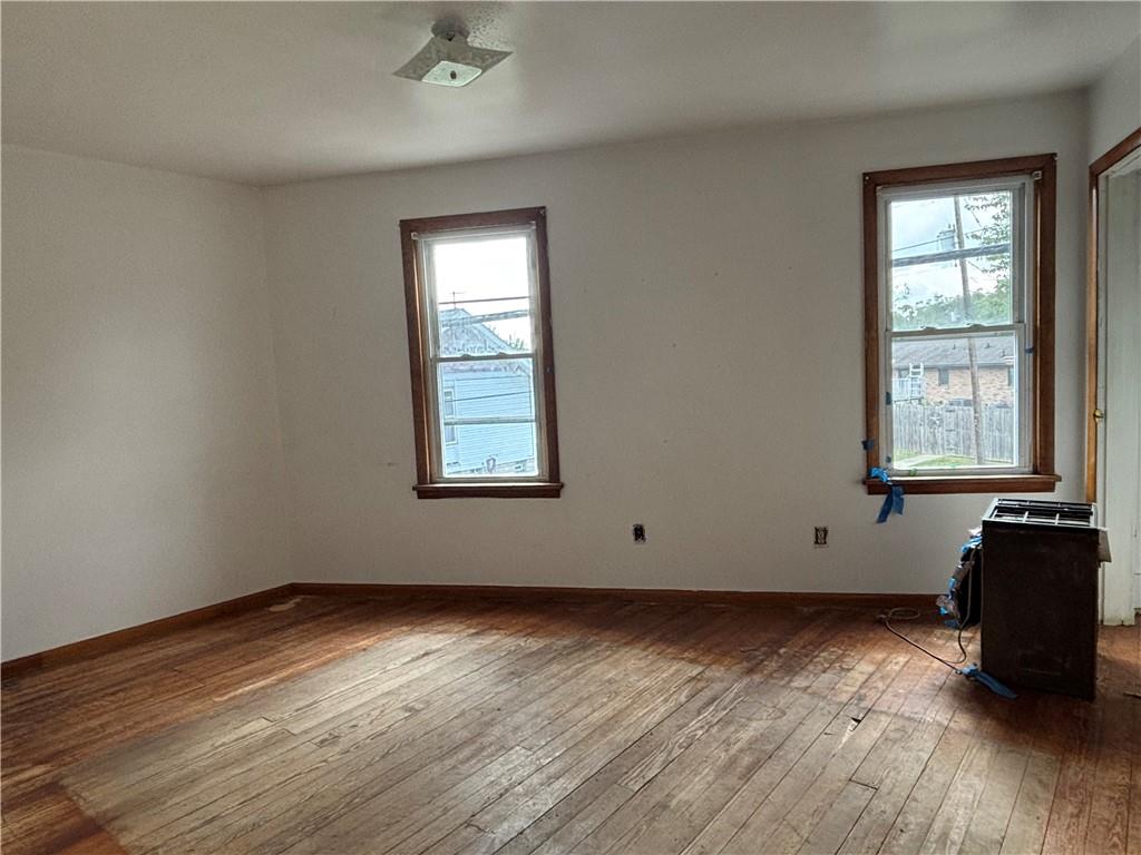 932 5th Street Charleroi, PA 15022 - Photo 22 of 26 an empty room with wooden floor and windows
