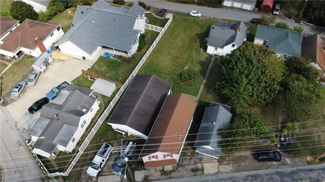 an aerial view of a house with garden space and street view