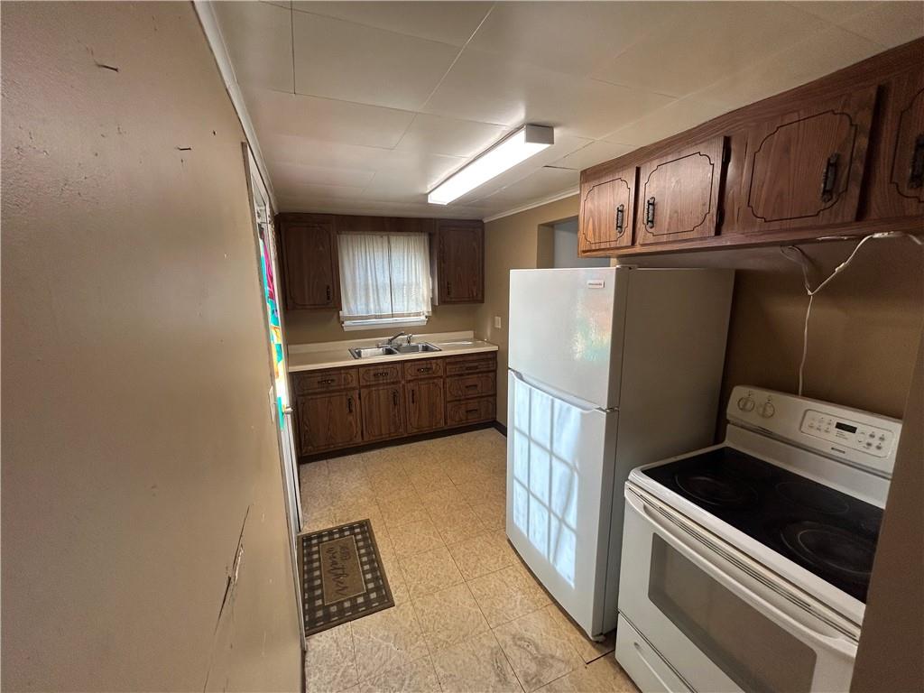 932 5th Street Charleroi, PA 15022 - Photo 9 of 26 a kitchen with refrigerator cabinets and microwave