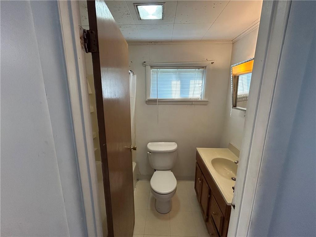 932 5th Street Charleroi, PA 15022 - Photo 10 of 26 a bathroom with a toilet a sink and a mirror