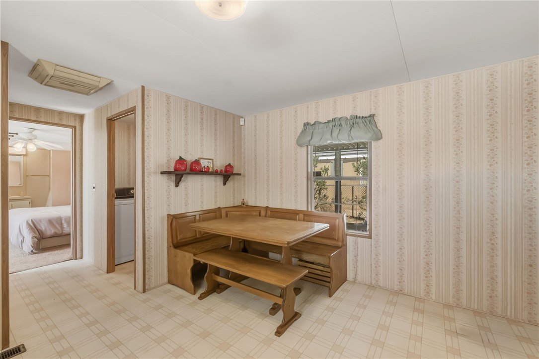 3880 Rising Sun Road Bullhead City, AZ 86442 - Photo 20 of 42 Built-in wooden dining nook with a matching table and bench seating