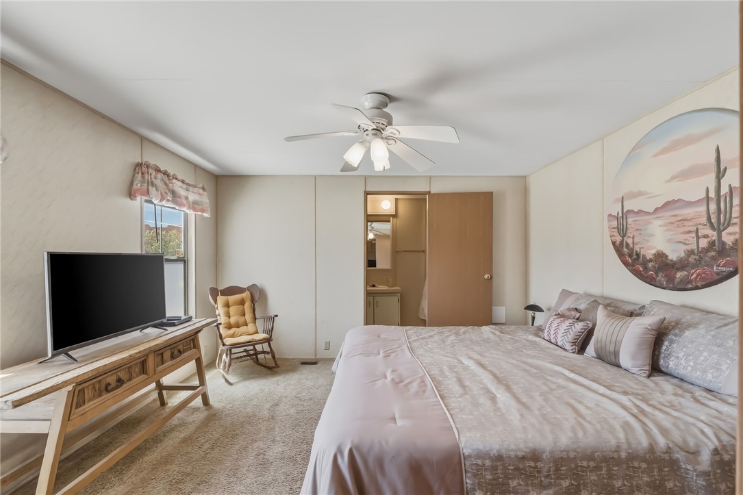 3880 Rising Sun Road Bullhead City, AZ 86442 - Photo 24 of 42 Bedroom featuring soft carpet flooring and a ceiling fan with integrated lighting