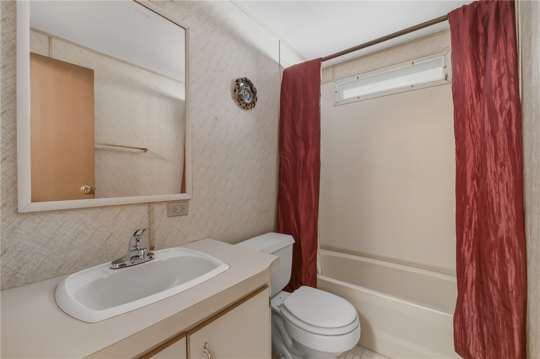 3880 Rising Sun Road Bullhead City, AZ 86442 - Photo 29 of 42 Bathroom featuring a vanity with an integrated sink, polished chrome faucet, and a wall-mounted mirror