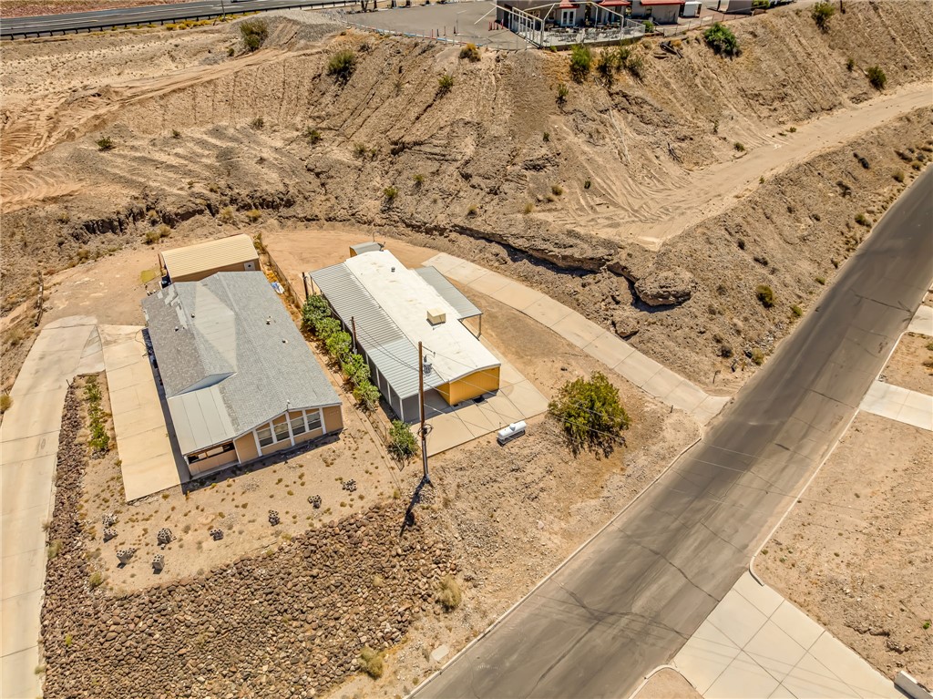3880 Rising Sun Road Bullhead City, AZ 86442 - Photo 35 of 42 Single-story residence featuring a shingled roof, light-toned exterior siding, and a prominent front driveway