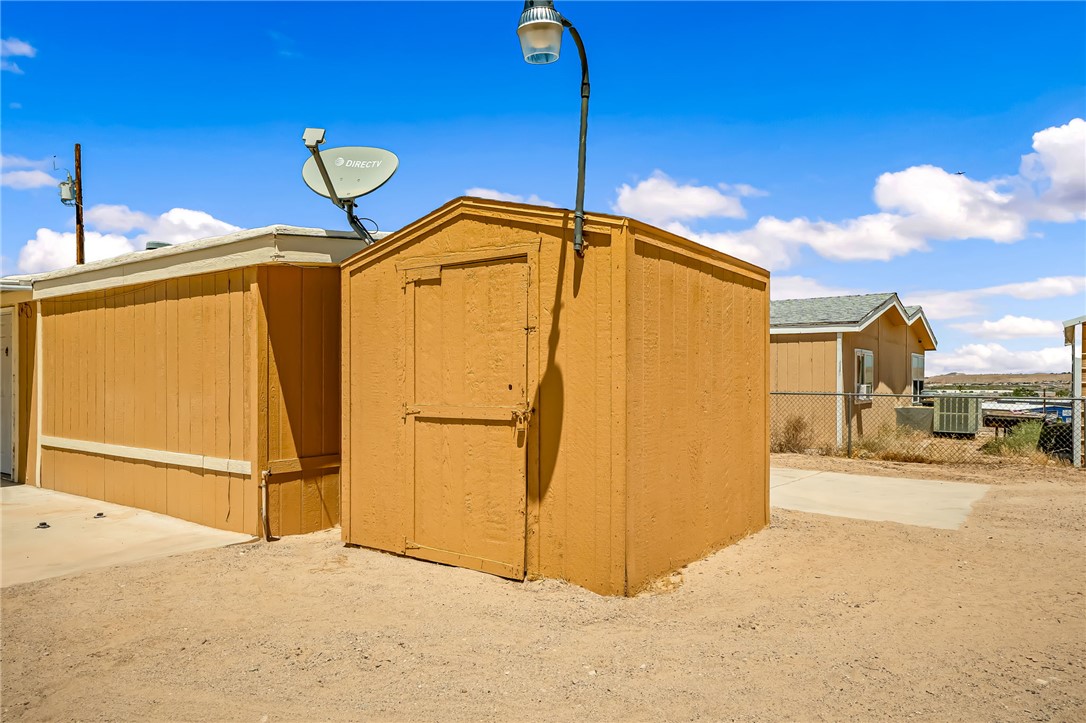 3880 Rising Sun Road Bullhead City, AZ 86442 - Photo 4 of 42 Freestanding storage shed with a gabled roof and a single entry door