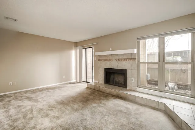 a view of an empty room with a fireplace