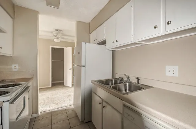 a kitchen with a stove and a refrigerator