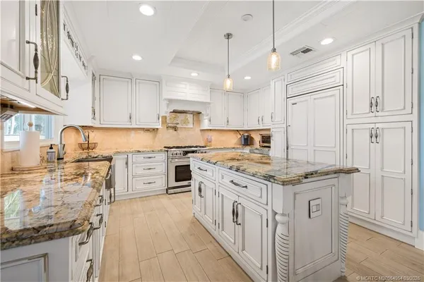 a kitchen with stainless steel appliances granite countertop a stove and a refrigerator