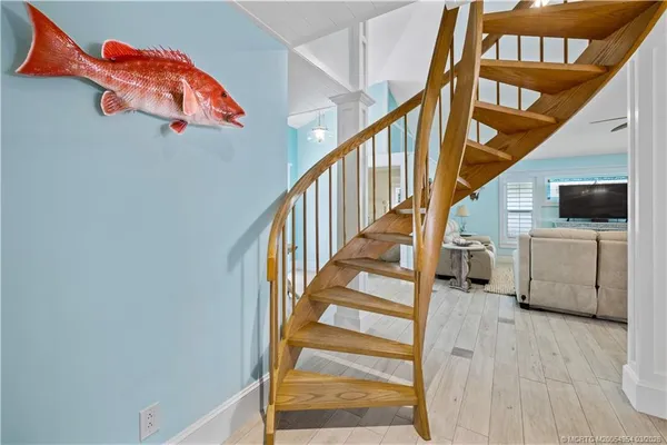 a view of hallway with wooden floor and stairs