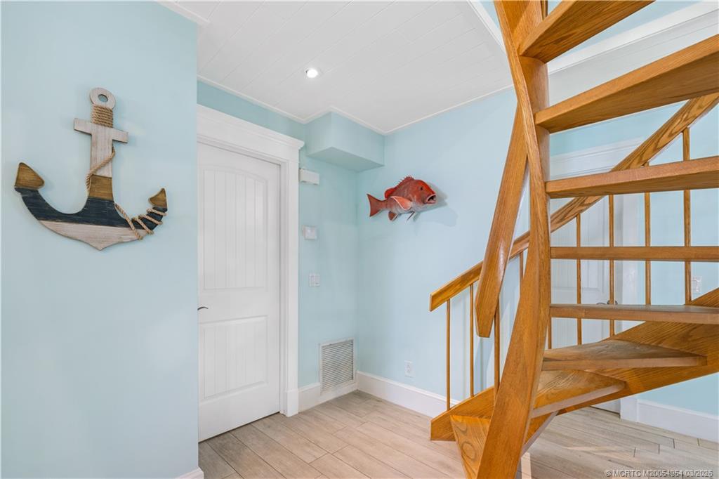 1359 Southwest Dyer Point Road Palm City, FL 34990 - Photo 17 of 55 a view of hallway with wooden floor and stairs
