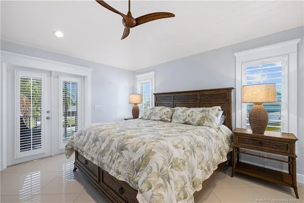 a bedroom with a bed and flat screen tv