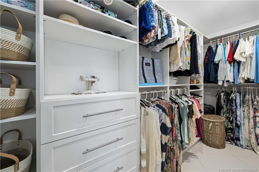 1359 Southwest Dyer Point Road Palm City, FL 34990 - Photo 24 of 55 a view of walk in closet with clothes and shoes