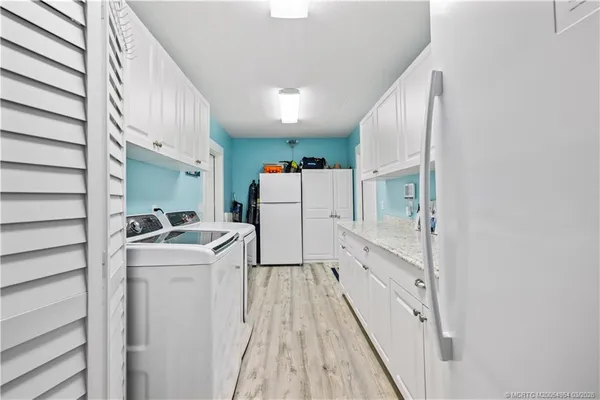 a view of a patio with a dining table and chairs with wooden floor