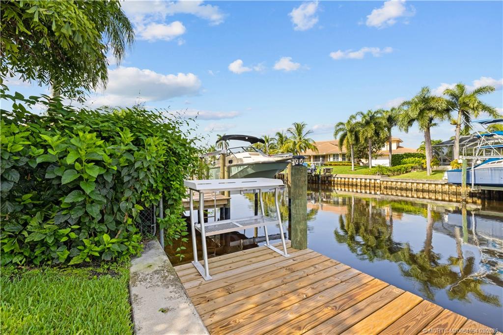 1359 Southwest Dyer Point Road Palm City, FL 34990 - Photo 40 of 55 a view of a chairs and table on the wooden deck