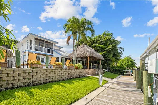 a dining room with furniture and a floor to ceiling window