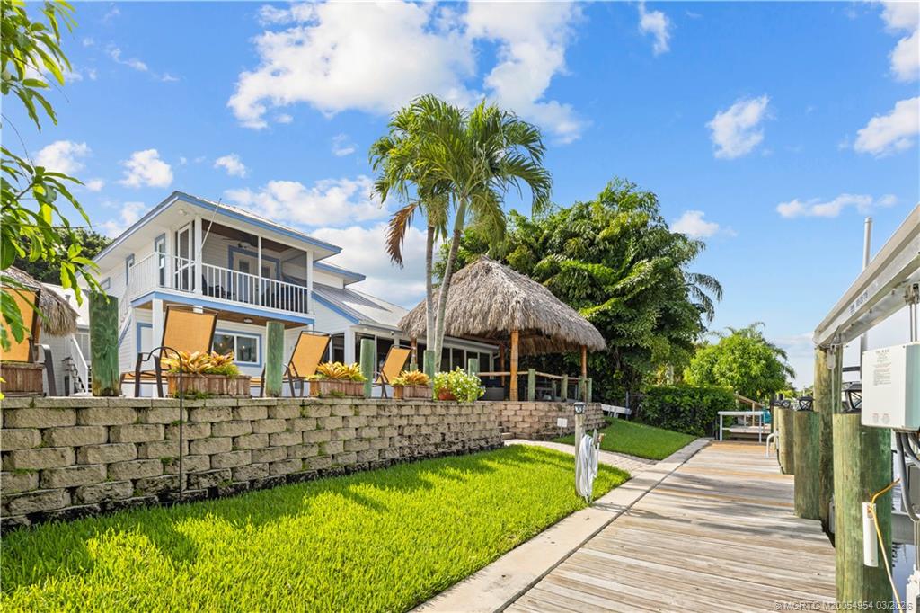 1359 Southwest Dyer Point Road Palm City, FL 34990 - Photo 41 of 55 a front view of a house with garden