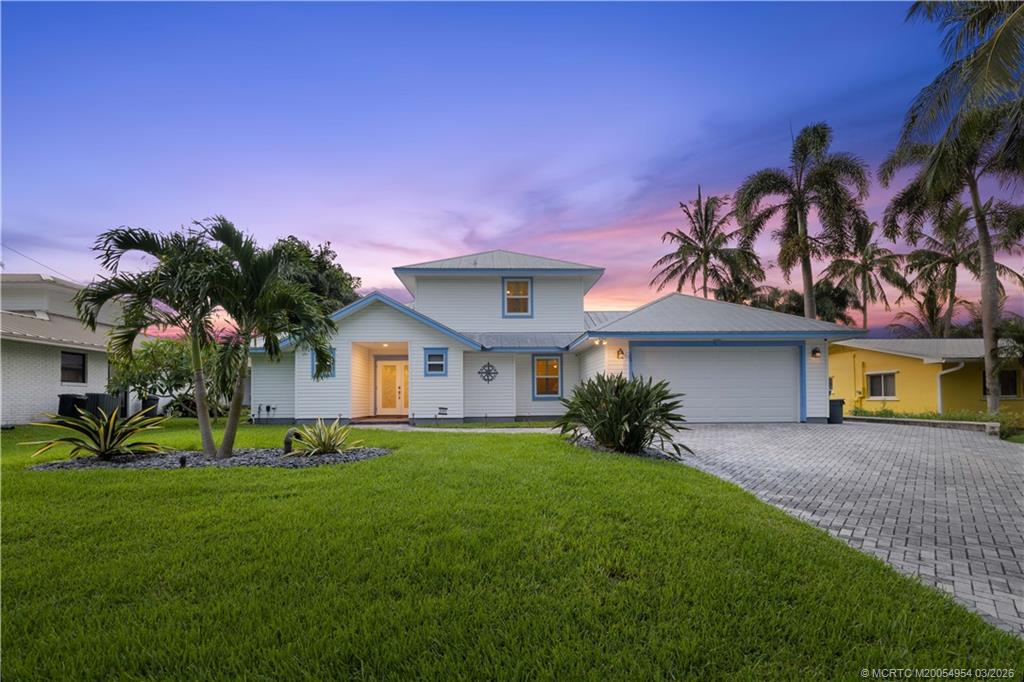 1359 Southwest Dyer Point Road Palm City, FL 34990 - Photo 5 of 55 a front view of a house with a yard and garage