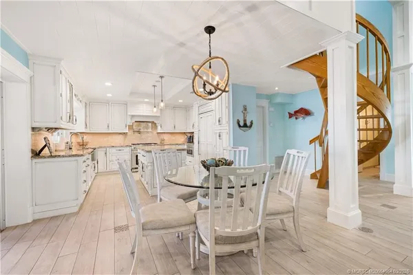 a view of a dining room with furniture wooden floor and a chandelier