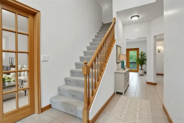 a kitchen with stainless steel appliances granite countertop a stove top oven a sink dishwasher a dining table and chairs with wooden floor