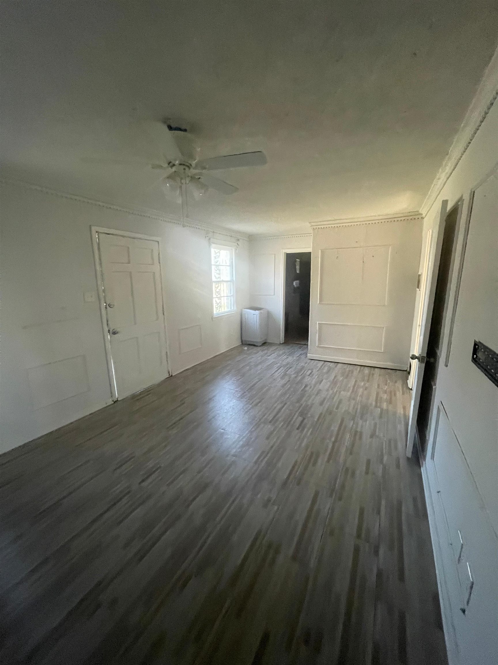 271 West Brooks Road Memphis, TN 38109 - Photo 5 of 17 Unfurnished living room featuring dark wood-type flooring and a ceiling fan