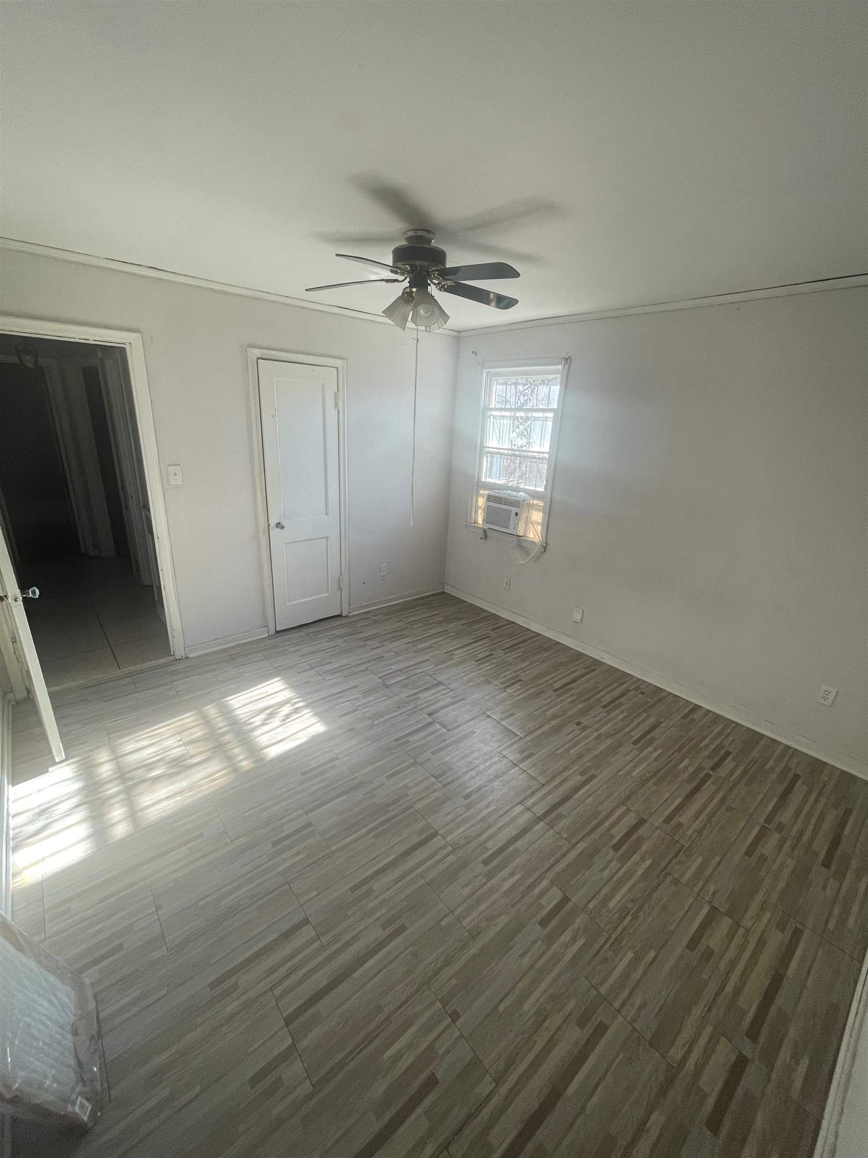 271 West Brooks Road Memphis, TN 38109 - Photo 6 of 17 Unfurnished bedroom featuring wood tiled floors, ceiling fan, and a closet
