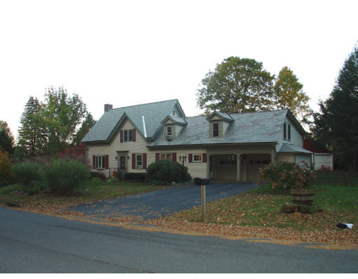 129 Walnut Hill Road Orange, MA 01364 - Photo 1 of 23 a view of a white house next to a yard with large trees