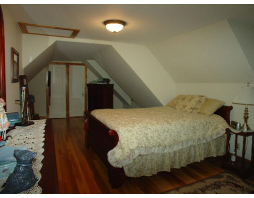 129 Walnut Hill Road Orange, MA 01364 - Photo 12 of 23 a bed room with a bed and a view of en suite bathroom