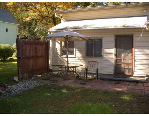 129 Walnut Hill Road Orange, MA 01364 - Photo 17 of 23 a view of a house with backyard porch and sitting area