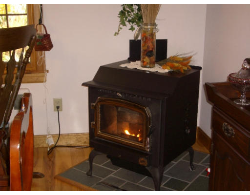 129 Walnut Hill Road Orange, MA 01364 - Photo 6 of 23 a living room with furniture a fireplace and a flat screen tv