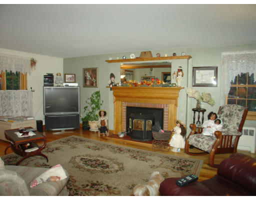 129 Walnut Hill Road Orange, MA 01364 - Photo 7 of 23 a living room with furniture a flat screen tv and a fireplace