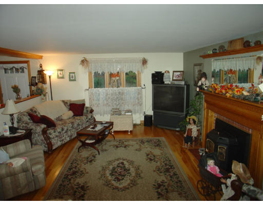 129 Walnut Hill Road Orange, MA 01364 - Photo 8 of 23 a living room with furniture and a fireplace