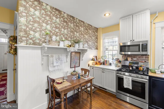 a kitchen with stainless steel appliances kitchen island granite countertop a stove a sink and a microwave