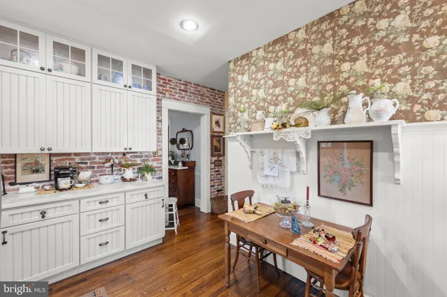 a open kitchen with a sink cabinets and wooden floor