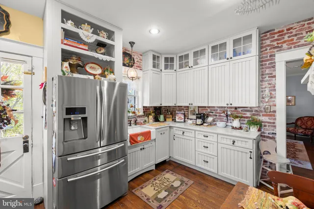 a kitchen with stainless steel appliances a refrigerator sink and cabinets