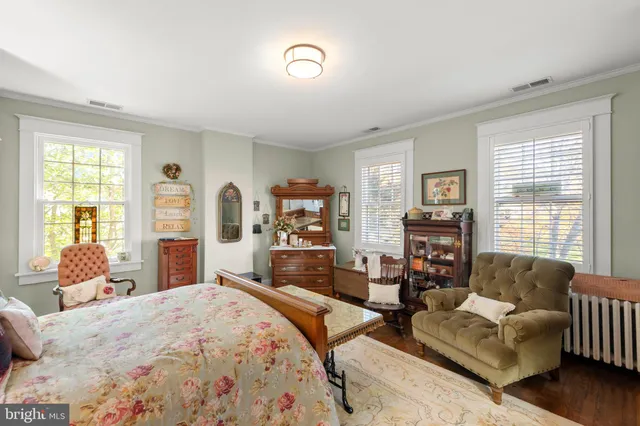 a bedroom with furniture and a large window