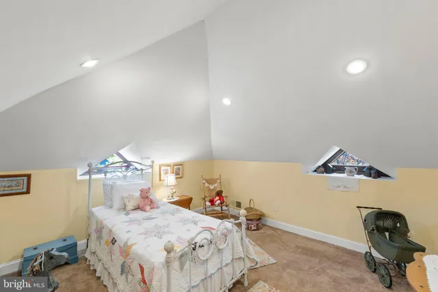 a bedroom with a bed and a bookshelf