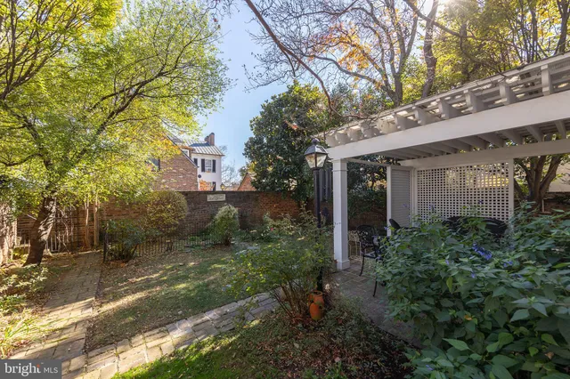 a backyard of a house with yard and outdoor seating