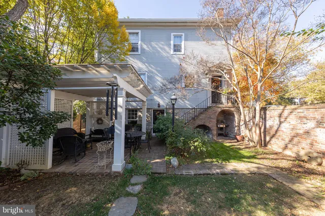 a backyard of a house with table and chairs