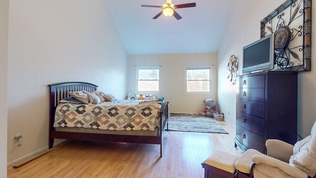 79 Arrowhead Circle, Unit 79 Ashland, MA 01721 - Photo 28 of 36 a bedroom with furniture and wooden floor