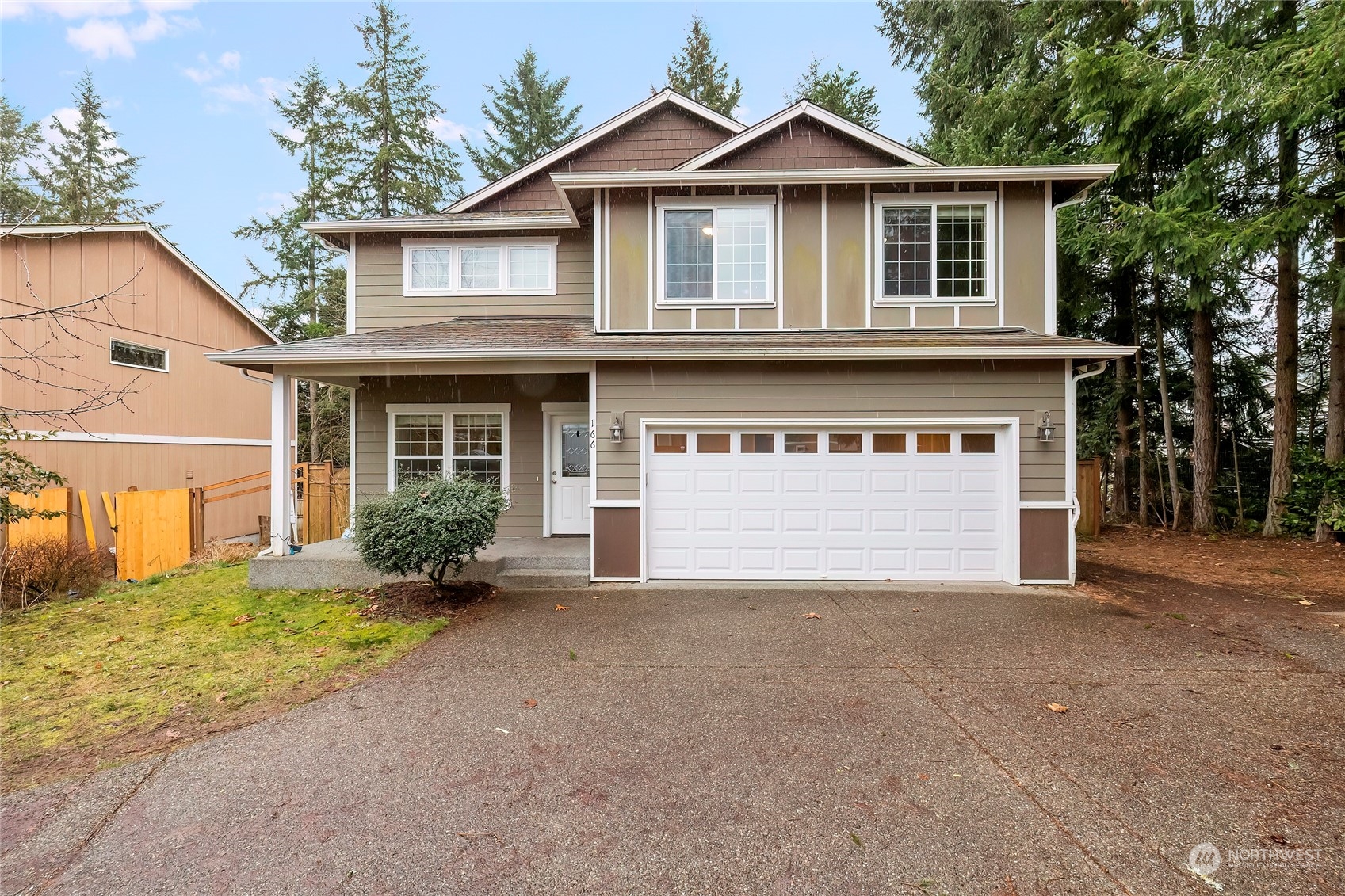 166 Gazebo Street Port Orchard, WA 98366 - Photo 1 of 22 a front view of a house with a yard and garage
