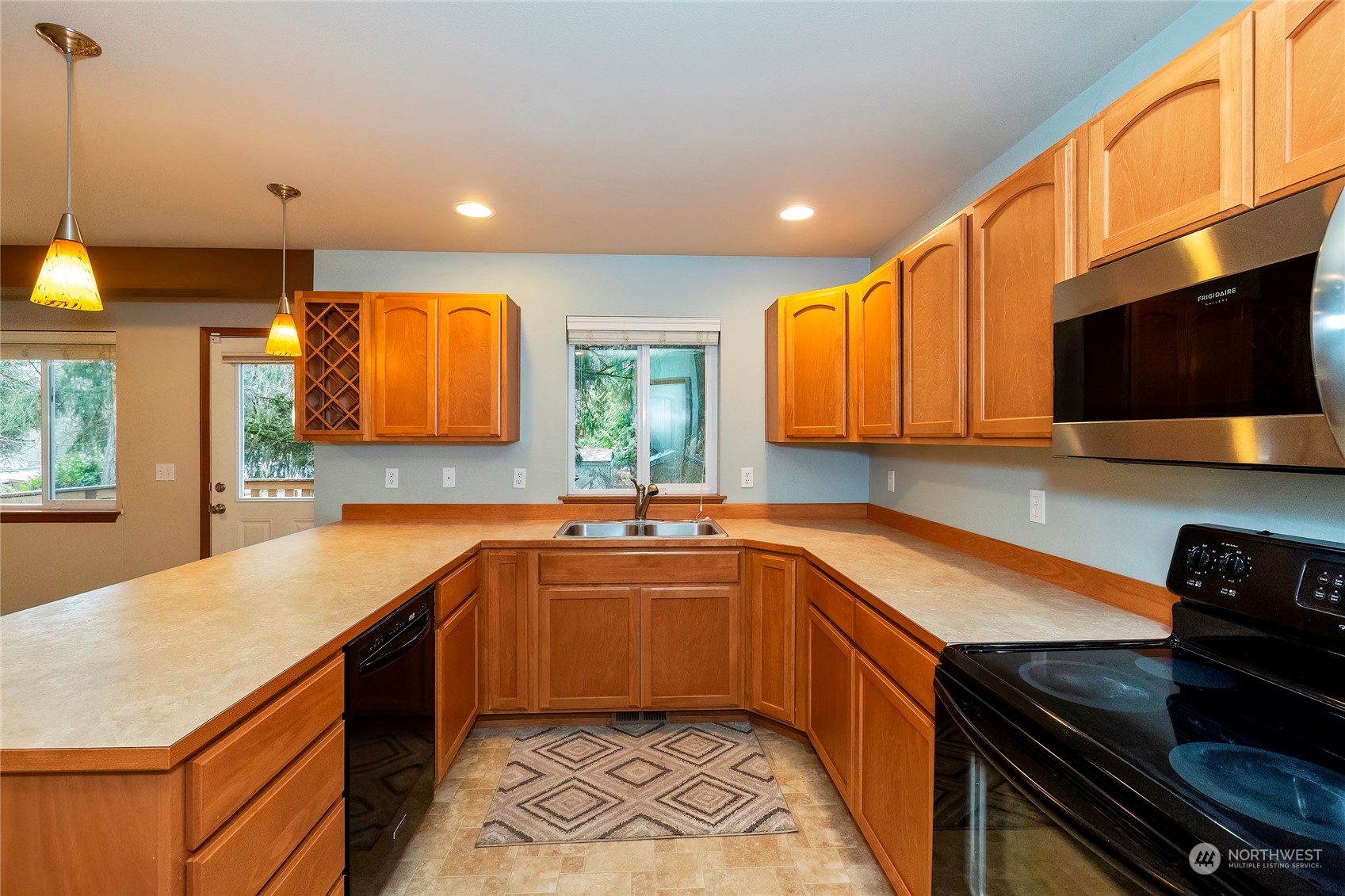 166 Gazebo Street Port Orchard, WA 98366 - Photo 12 of 22 a kitchen with stainless steel appliances a sink stove and cabinets