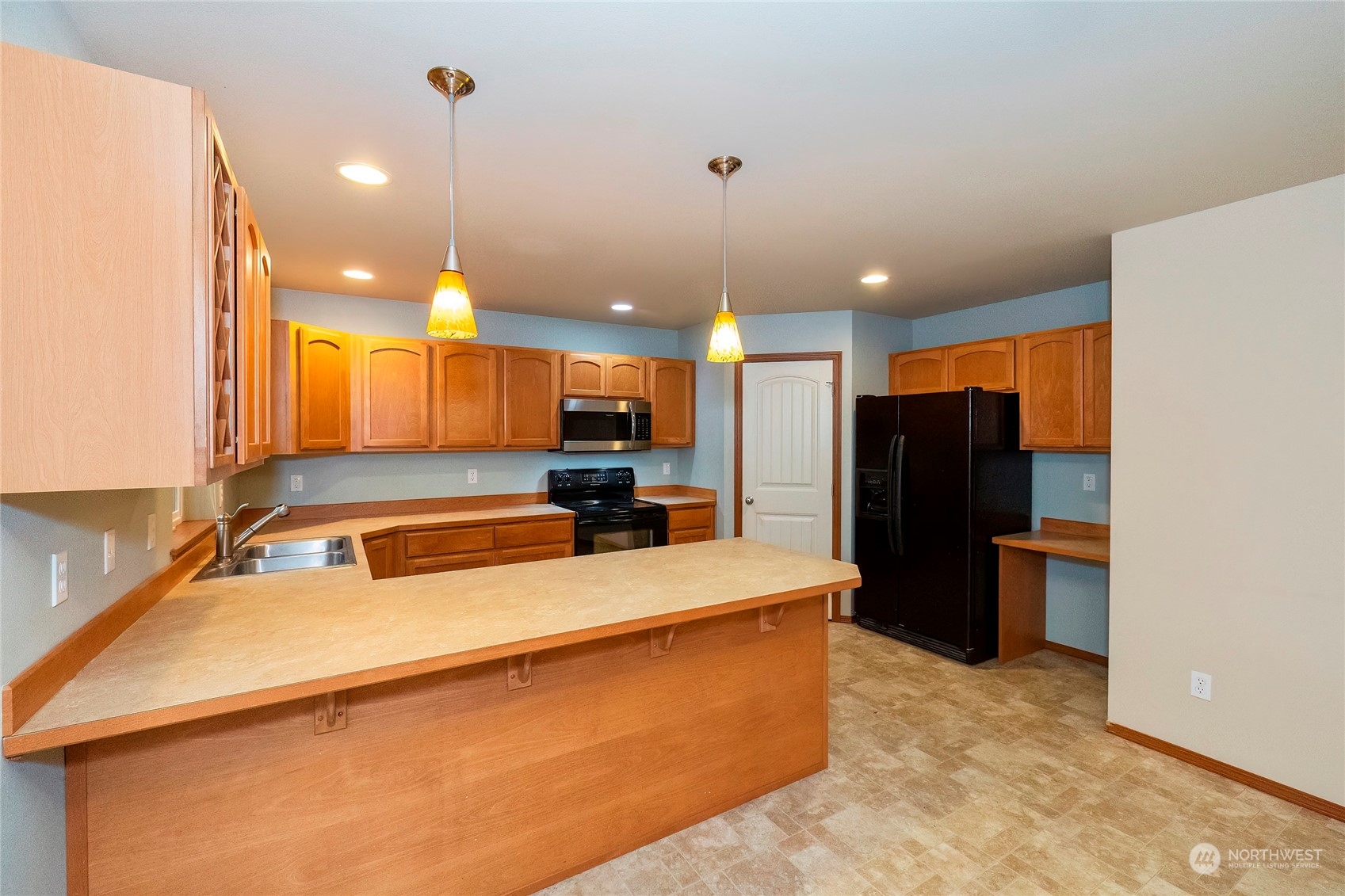 166 Gazebo Street Port Orchard, WA 98366 - Photo 13 of 22 a large kitchen with a large counter top a refrigerator and a sink