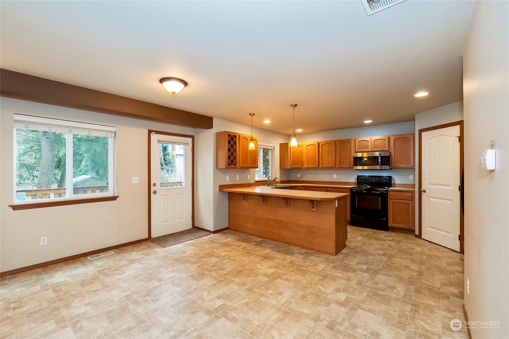 166 Gazebo Street Port Orchard, WA 98366 - Photo 9 of 22 a large kitchen with kitchen island a sink stainless steel appliances and cabinets