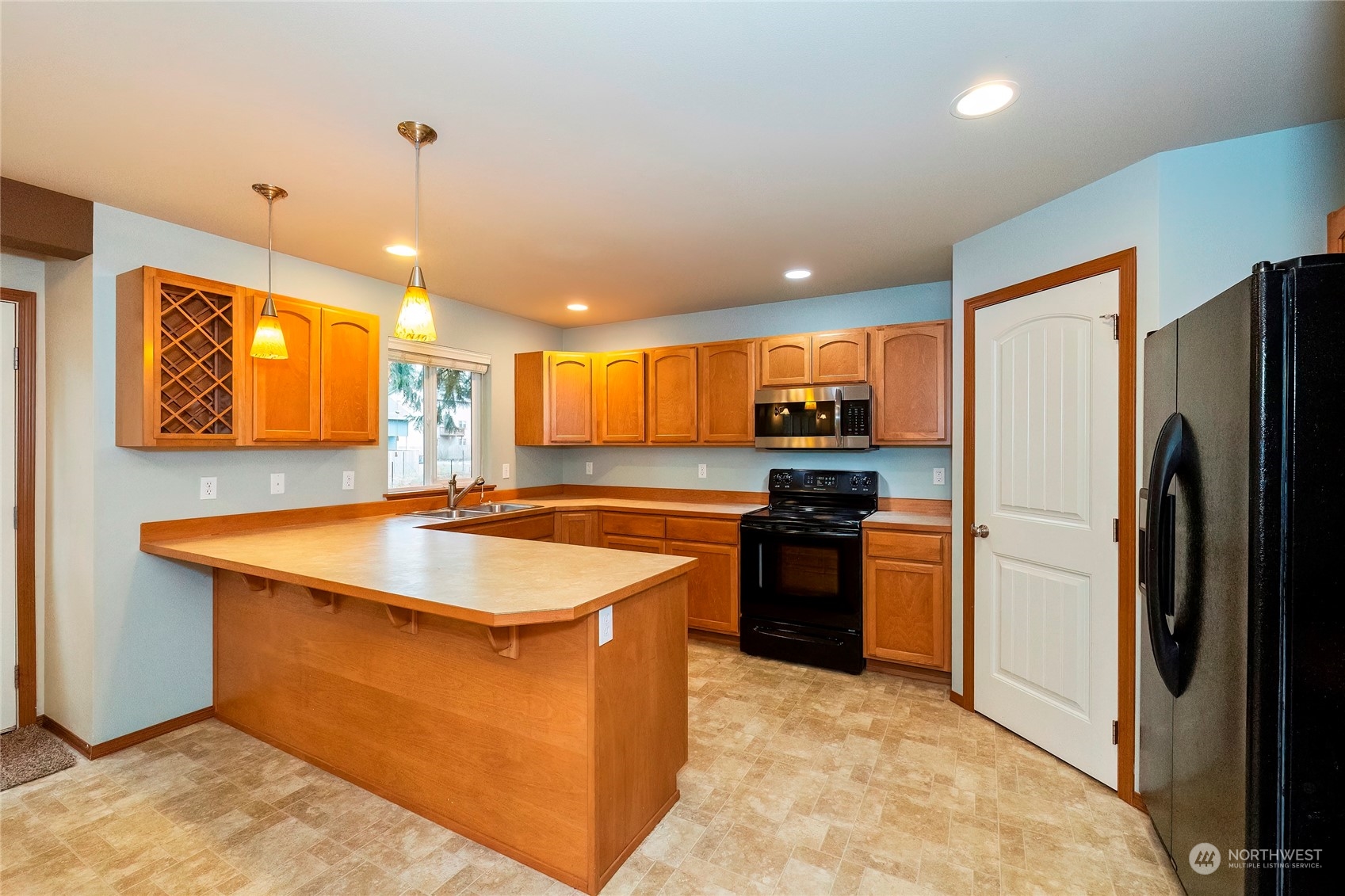 166 Gazebo Street Port Orchard, WA 98366 - Photo 10 of 22 a kitchen with stainless steel appliances granite countertop a sink a stove and a refrigerator